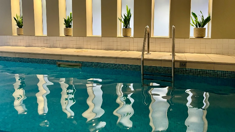 a large swimming pool with a row of windows